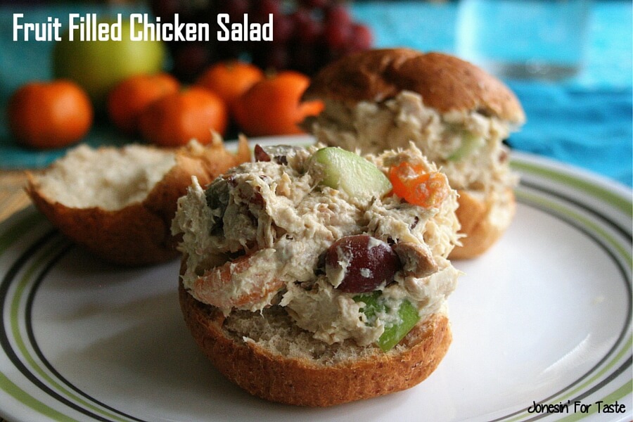 chicken salad with mandarin oranges, grapes, and apples on a roll