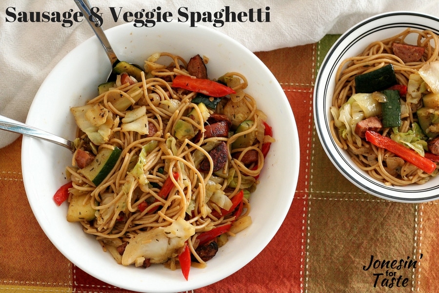 Sausage and Veggie Spaghetti in a large white bowl next to small bowl filled with more pasta