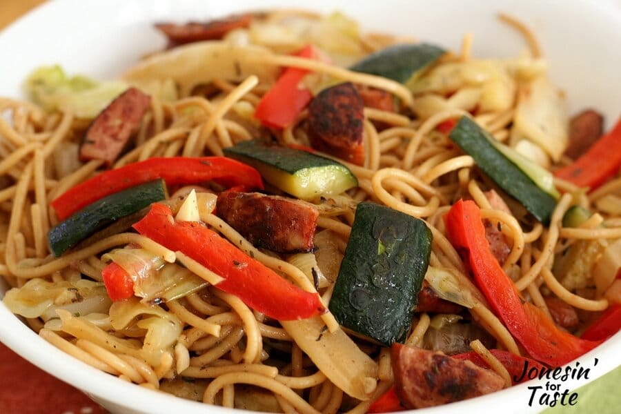 A close up of the Sausage and Veggie Spaghetti with strips of red pepper and zucchini on top of the pasta