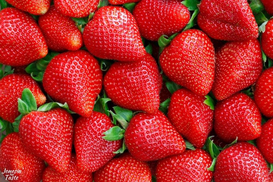 dozens of large ripe red strawberries packed tightly together