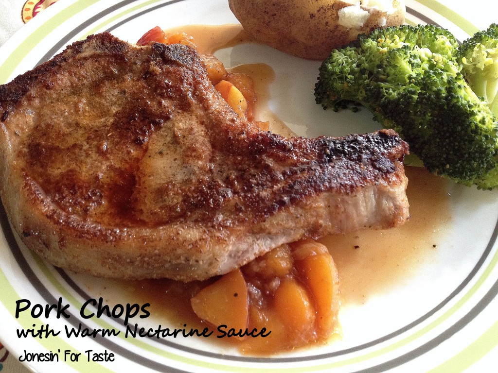 A pork chop with nectarine sauce on a plate with a baked potato and broccoli
