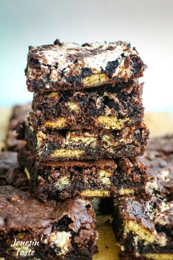 A stack of brownies with graham crackers, chocolate pieces, and marshmallow fluff