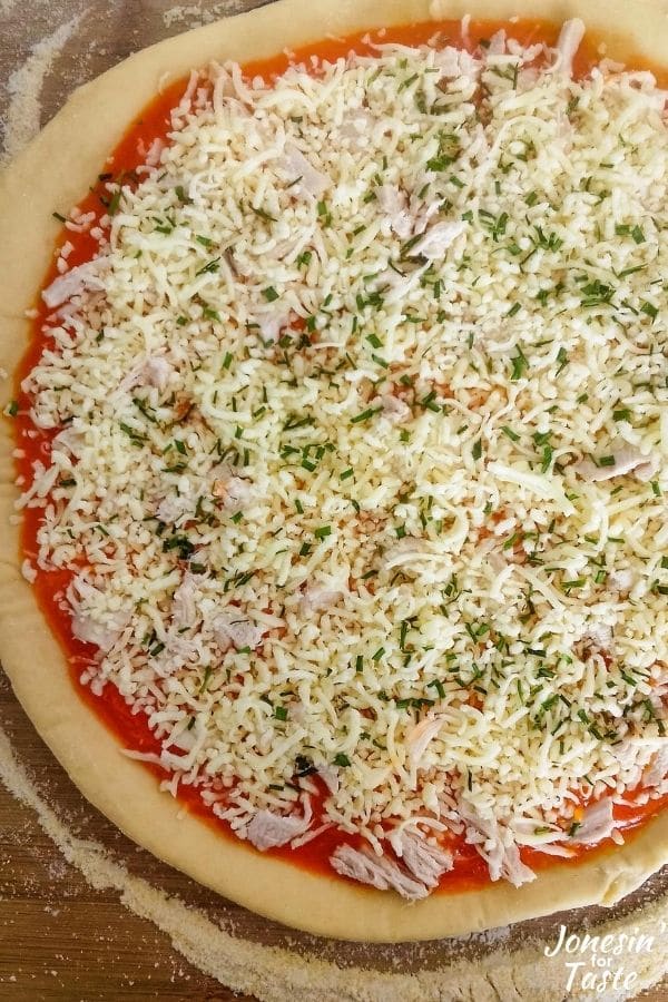 Green onions topping a buffalo chicken pizza