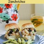Two tropical chicken salad sandwiches on a plate with snap pea crisps.
