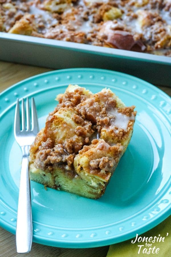 A slice of cinnamon roll french toast bake on a blue plate