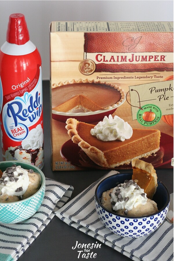 A box of pumpkin pie and a bottle of Reddi-Wip behind two bowls of Pumpkin Pie Ice Cream Sundaes