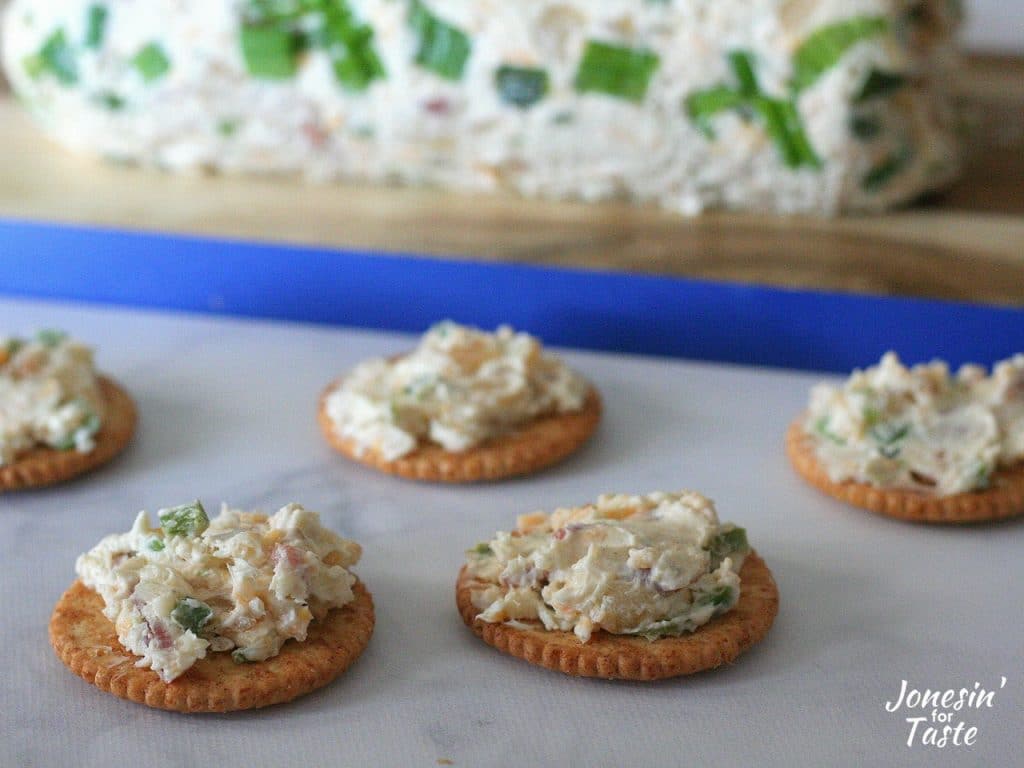Ritz crackers with Bacon and Jalapeno Cheese Log spread on them.