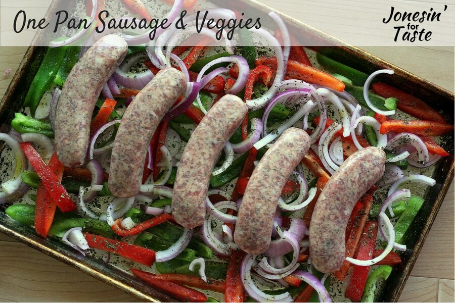 uncooked sausages and veggies on a cookie sheet