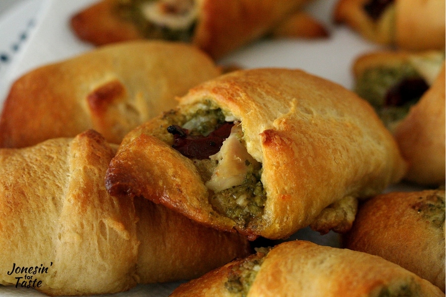 A closeup view of the chicken, pesto, and sun dried tomato filling in the croissants.