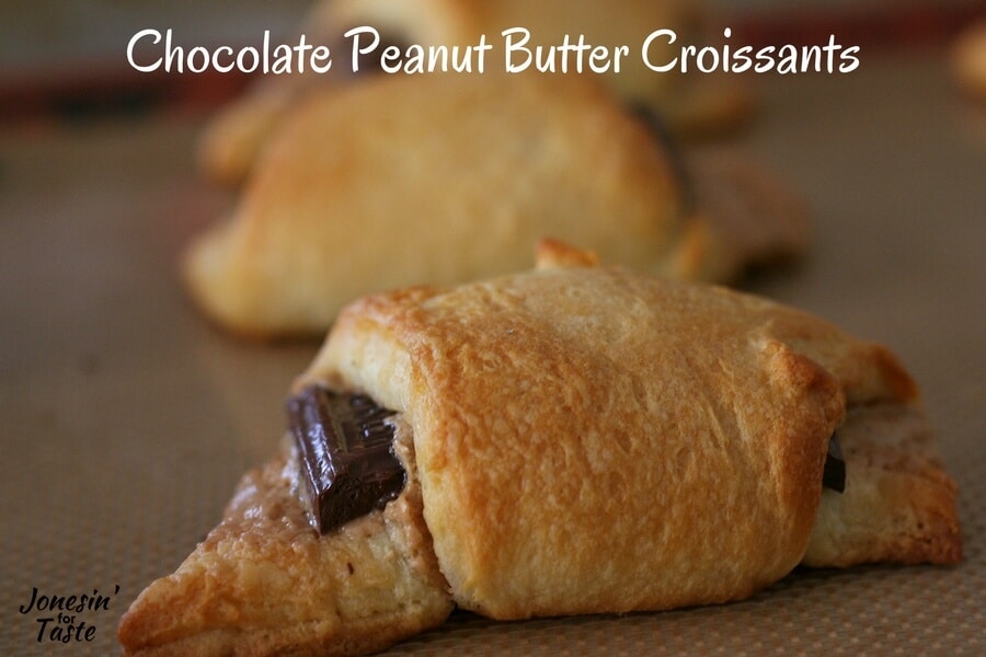 A cooked chocolate peanut butter croissant on a cookie sheet.