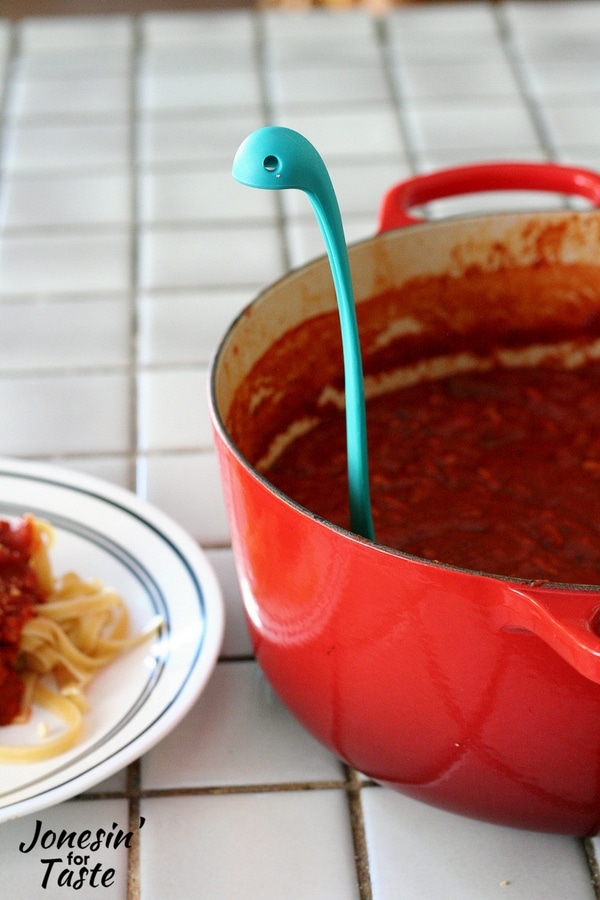 A pot of Turkey Spaghetti Sauce with a blue Loch Ness Monster ladle 