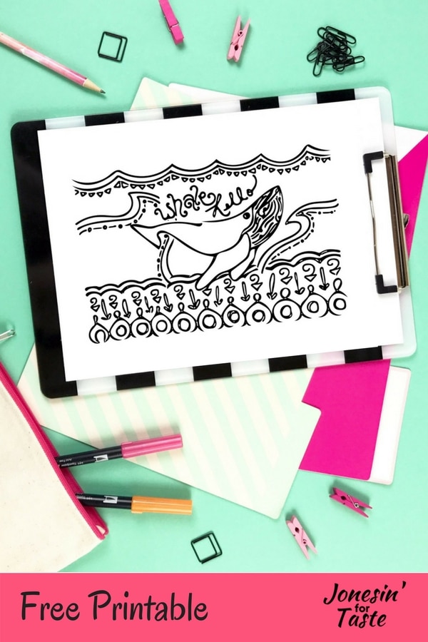 A desk with coloring supplies and a clipboard holding a whale coloring page
