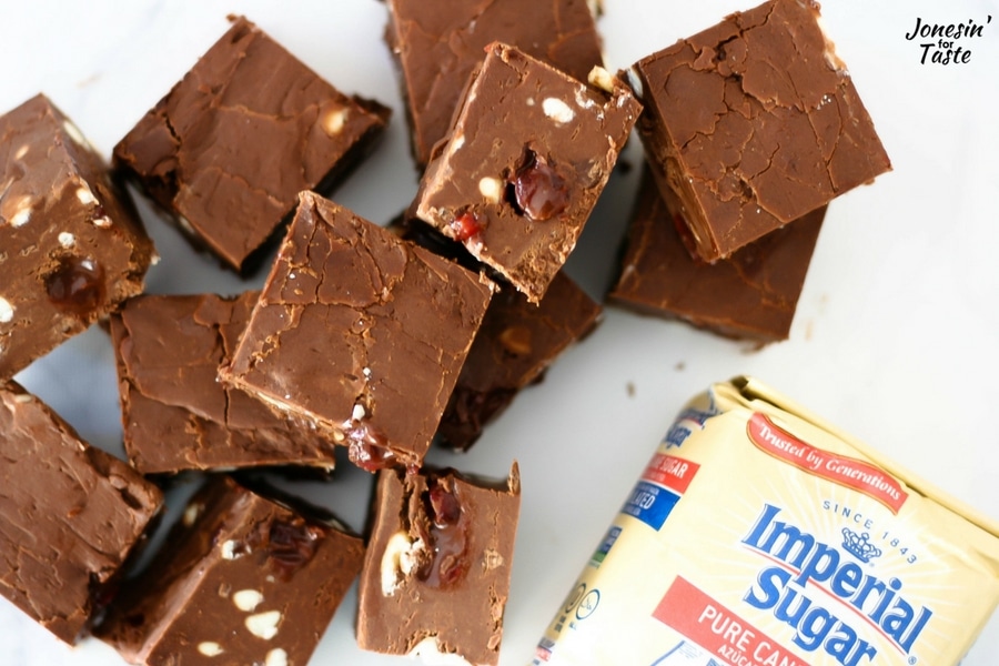 Large squares of Cherry Chocolate Fudge lying next to a bag of Imperial Sugar.