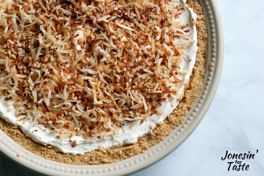 Looking down on a toasted shredded coconut topped no bake key lime pie