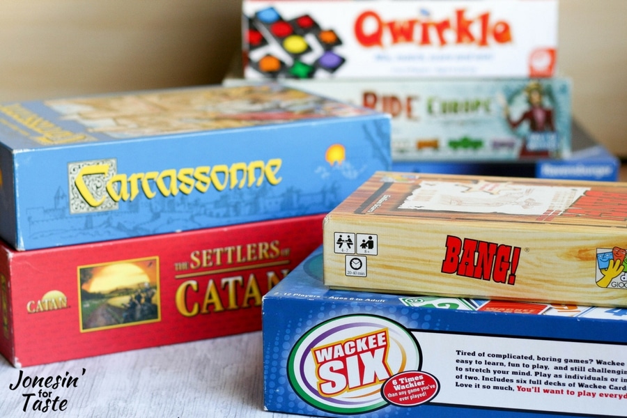 Board games for family game night for older children sorted and displayed into various stacks
