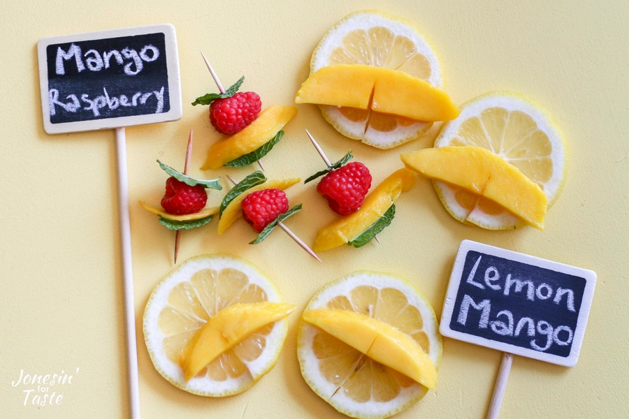 Raspberry mango and mint on a toothpick and lemon and mango slices