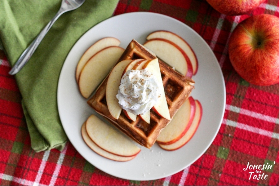 Chai spiced apple waffles topped with sliced apples and whipped cream