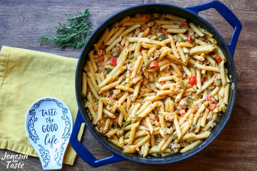 A blue pot with pumpkin sausage penne pasta in it