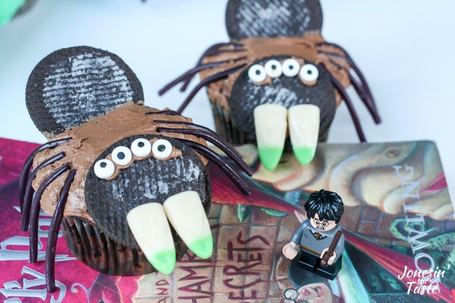 A Harry Potter Lego figurine next to Harry Potter spider cupcakes