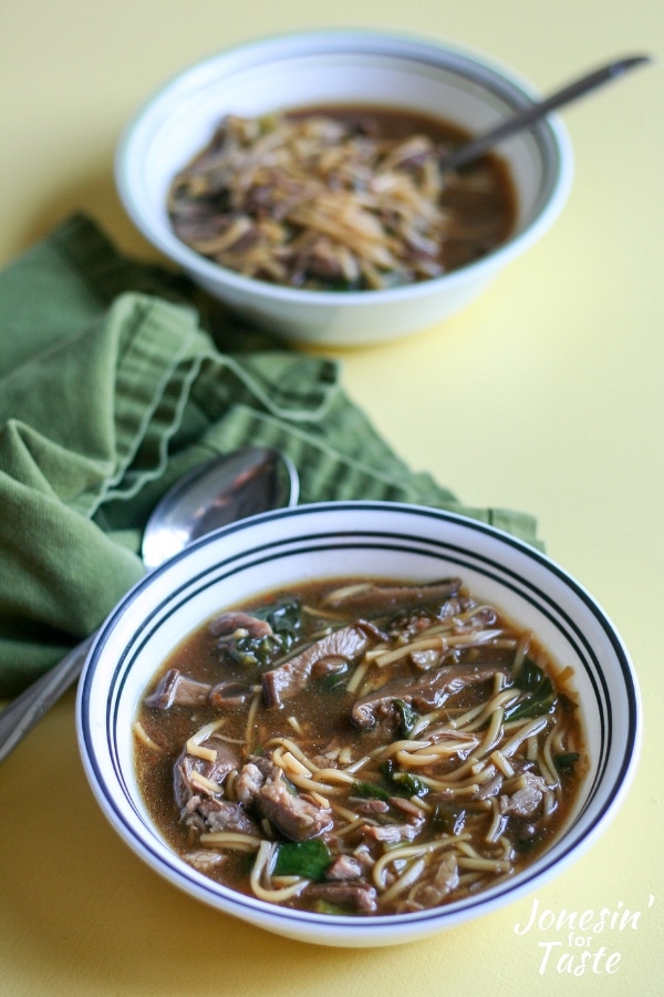 Two bowls of chinese pork shoulder soup on a yellow table
