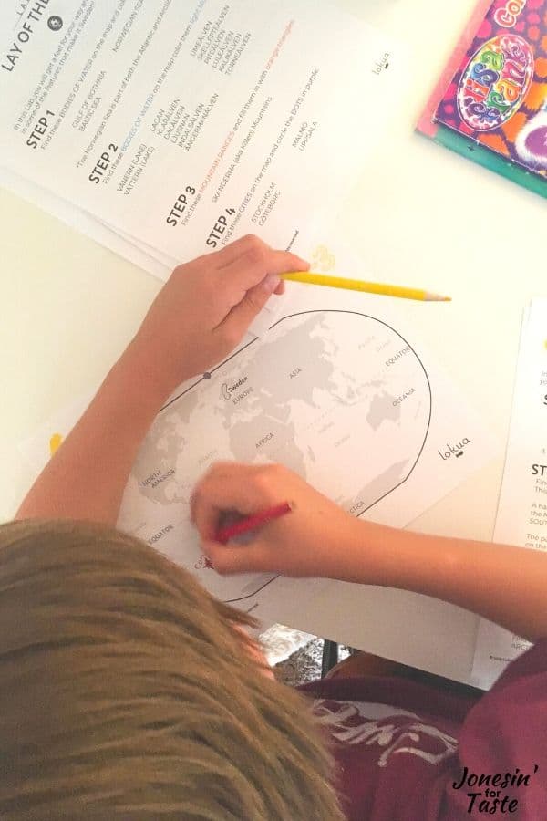 a child doing schoolwork with a world map