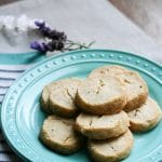 Lavender cookies stacked in layers on a plate.