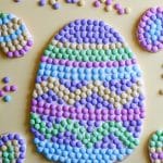 An Easter Egg cookie pizza with several mini Easter egg cookies