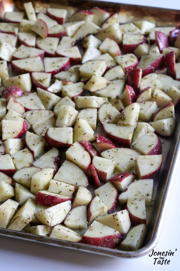 A pan of uncooked potatoes ready to go into the oven