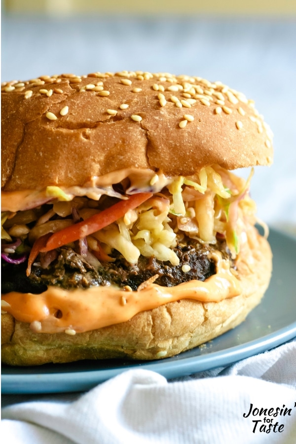 A korean bbq burger with siracha mayo, a burger patty topped with Korean coleslaw
