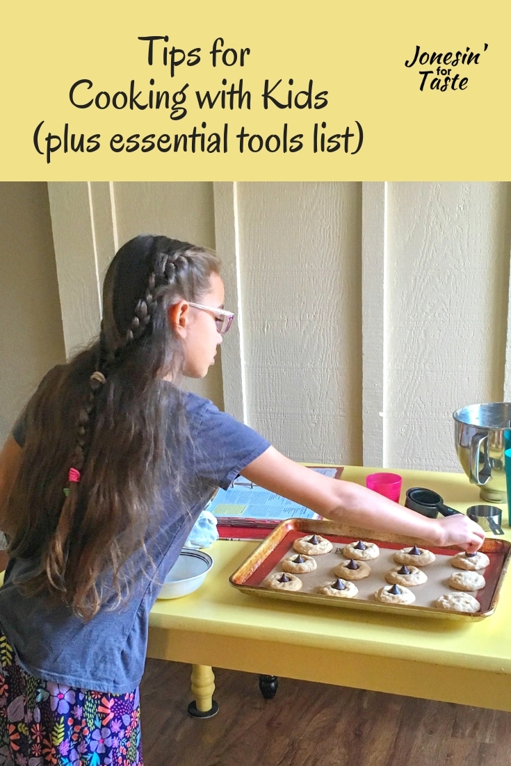 A girl adding decorations to cooked cookies