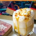 a butterbeer ice cream float next to harry potter books