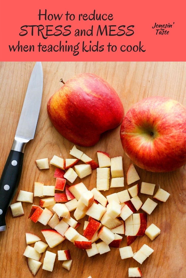 a paring knife next to chopped red apples