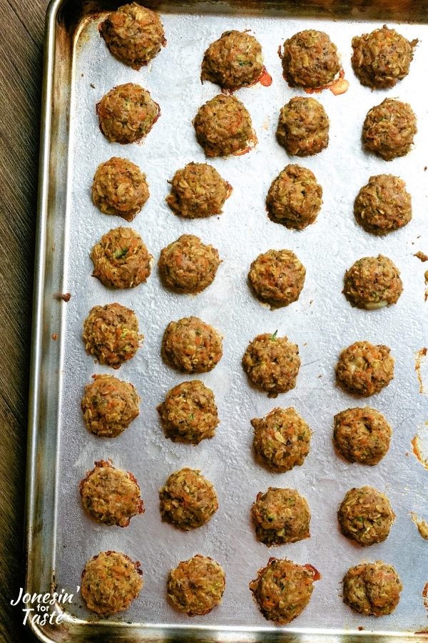 rows of meatballs on a cookie sheet