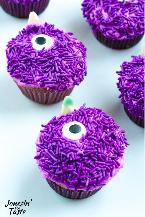 cupcakes covered with purple sprinkles and giant candy eyes