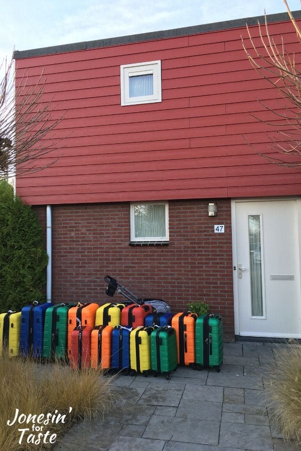 colorful suitcases outside of a house