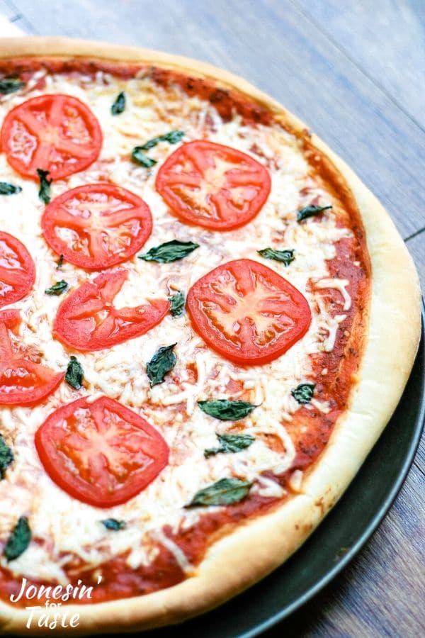 a cooked tomato and basil pizza