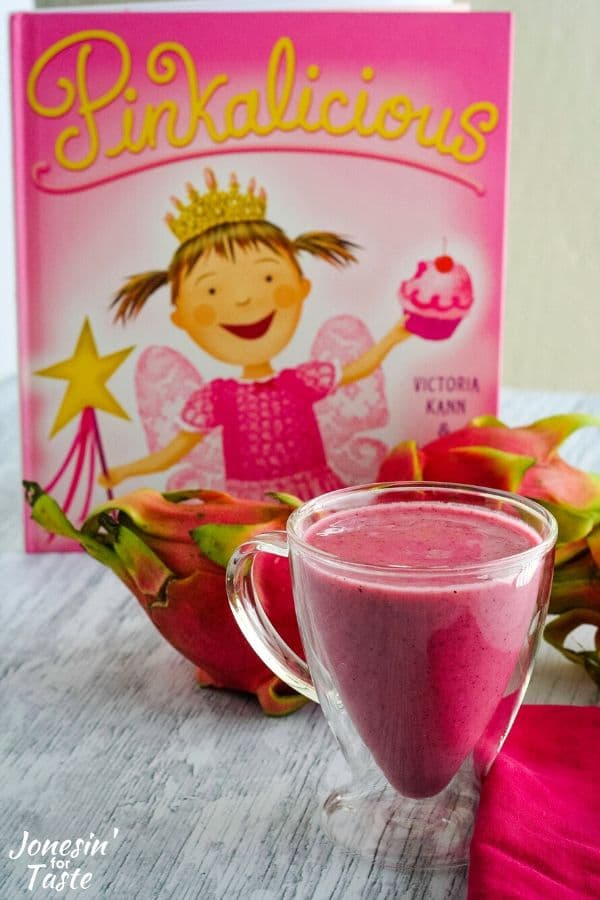 a cup of pink smoothie in front of the book pinkalicious