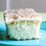 a coconut cake topped with coconut frosting and toasted coconut