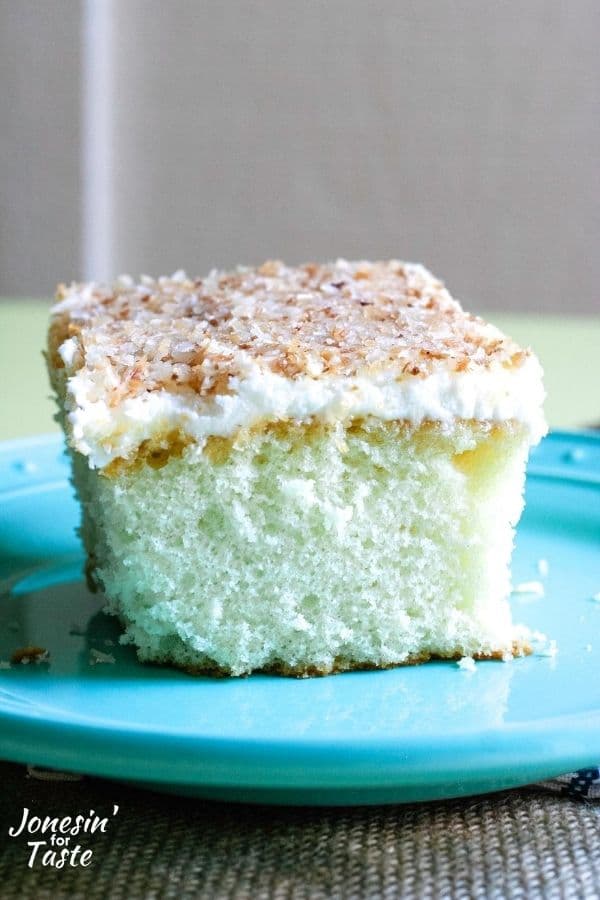 a coconut cake topped with coconut frosting and toasted coconut