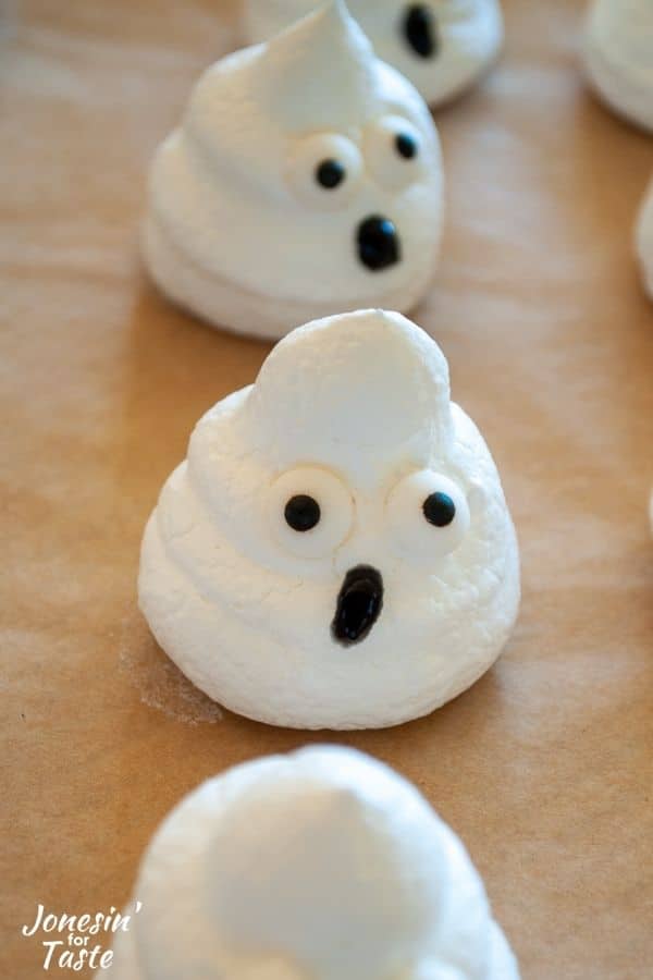a meringue ghost with candy eyes and an icing mouth