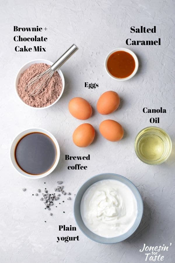 various cake ingredients in bowls on a white background