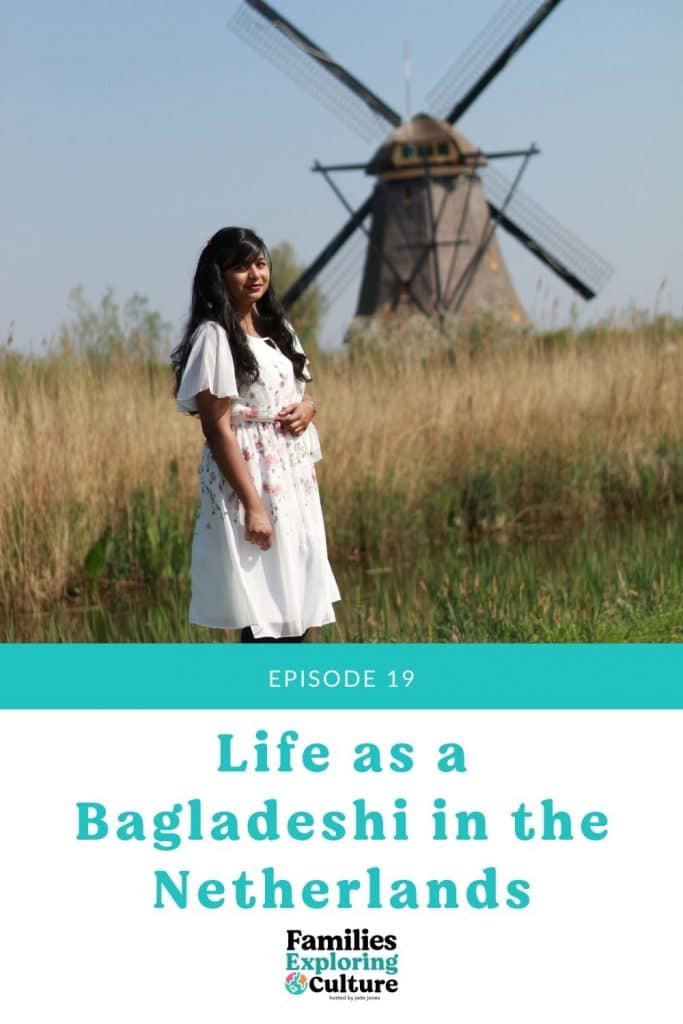 a picture of Neela posing in a white dress with a windmill in the background.