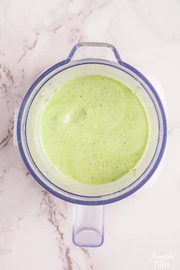 looking down into a blender filled with a smooth light green puree
