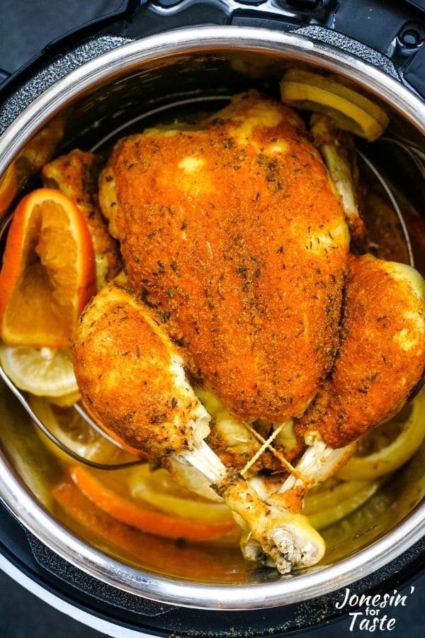 a cooked whole chicken in a pressure cooker pot